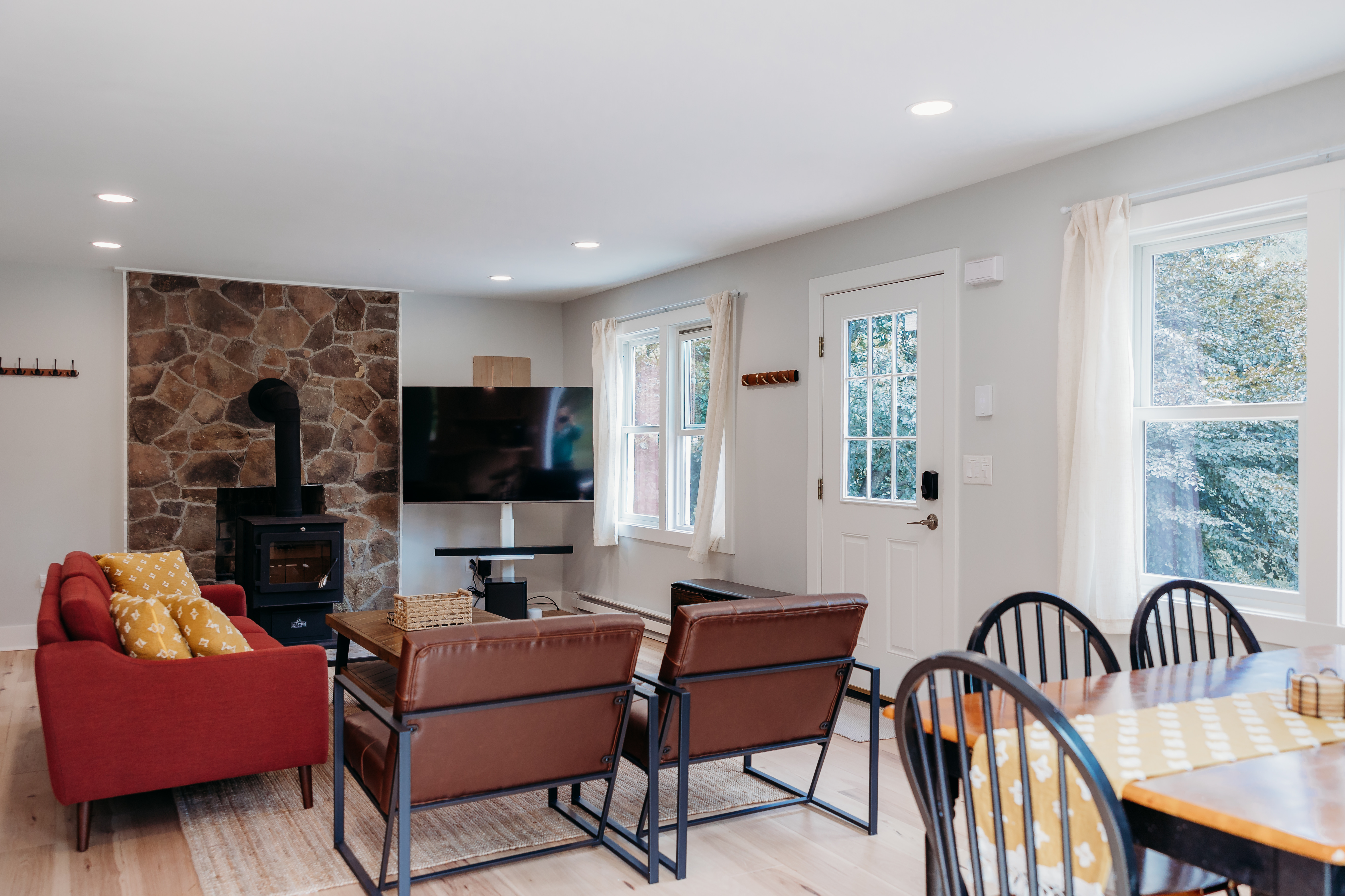 Living room with wood stove and stone wall